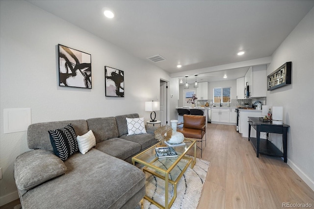 living room with light hardwood / wood-style flooring