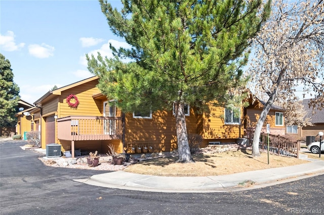 view of front of home featuring central AC and an attached garage