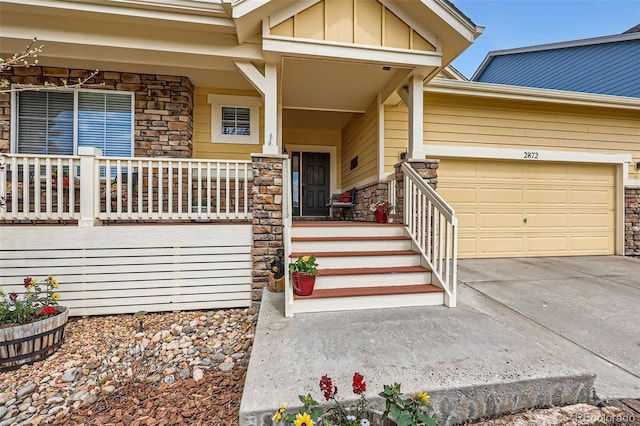 2872 Dreamcatcher Loop, Castle Rock, CO 80109 - doorway to property with stone siding, a porch, board and batten siding, concrete driveway, and an attached garage