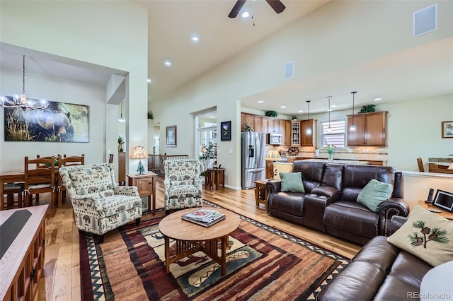 2872 Dreamcatcher Loop, Castle Rock, CO 80109 - living room featuring light wood finished floors, ceiling fan, a chandelier, recessed lighting, and high vaulted ceiling