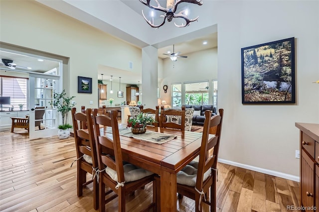 2872 Dreamcatcher Loop, Castle Rock, CO 80109 - dining space with a ceiling fan, light wood-type flooring, a chandelier, a towering ceiling, and recessed lighting