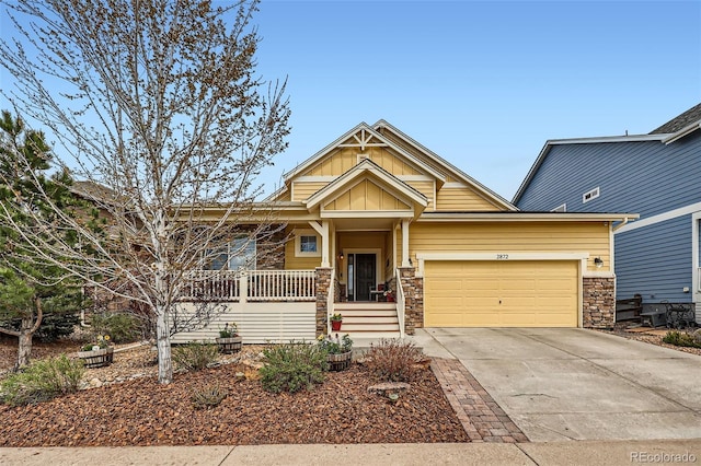2872 Dreamcatcher Loop, Castle Rock, CO 80109 - craftsman house featuring stone siding, concrete driveway, covered porch, and a garage