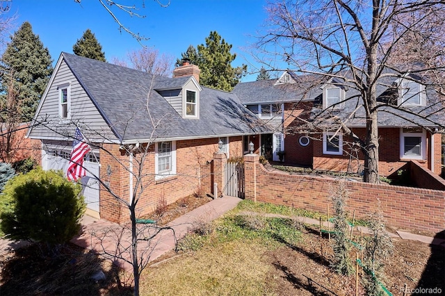 cape cod-style house featuring a chimney and brick siding