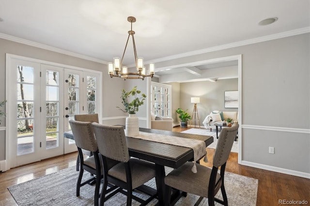 dining space with french doors, plenty of natural light, wood finished floors, and baseboards