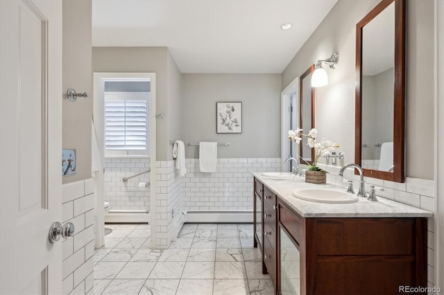 bathroom with toilet, marble finish floor, a baseboard heating unit, and a sink