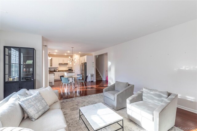 living area with stairs, baseboards, recessed lighting, and wood finished floors