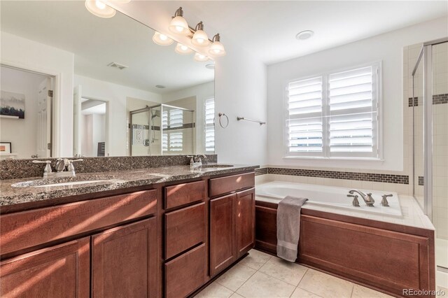 bathroom featuring a garden tub, tile patterned flooring, a shower stall, and a sink