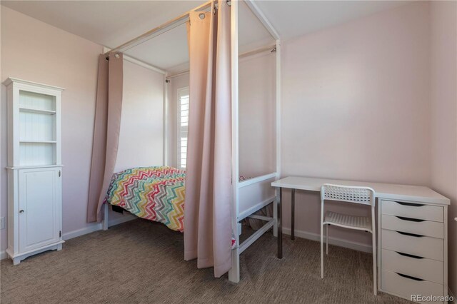 bedroom featuring carpet and baseboards