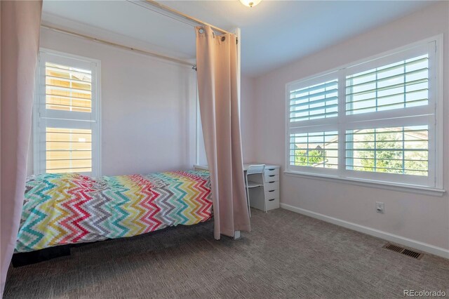 carpeted bedroom with baseboards and visible vents