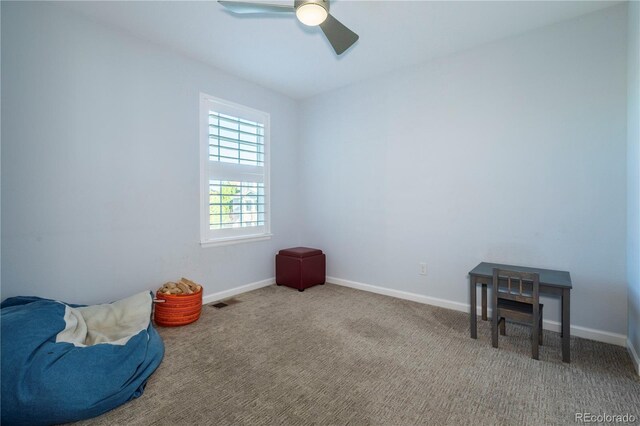 interior space featuring baseboards, carpet flooring, and ceiling fan