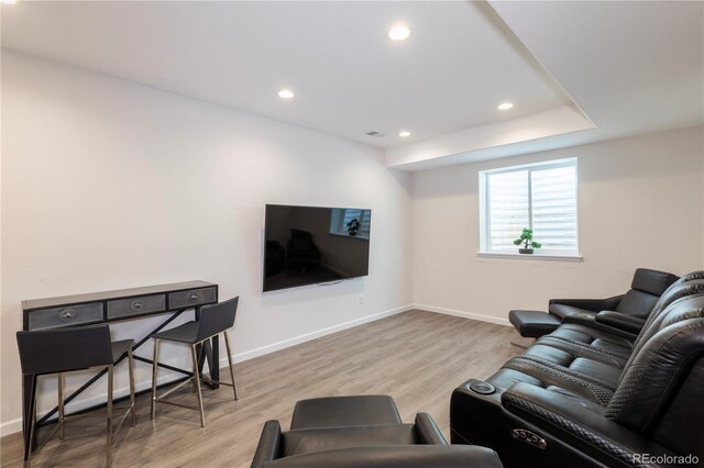 living area featuring wood finished floors, baseboards, and recessed lighting