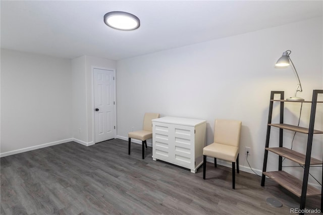 living area with dark wood finished floors and baseboards