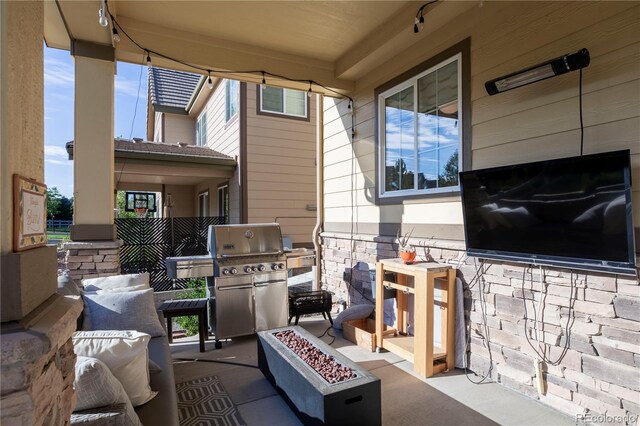 view of patio with an outdoor fire pit and area for grilling
