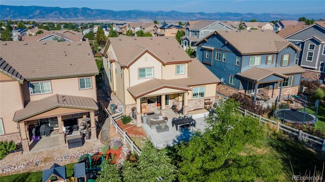 rear view of property with a patio, a residential view, a mountain view, and a fenced backyard