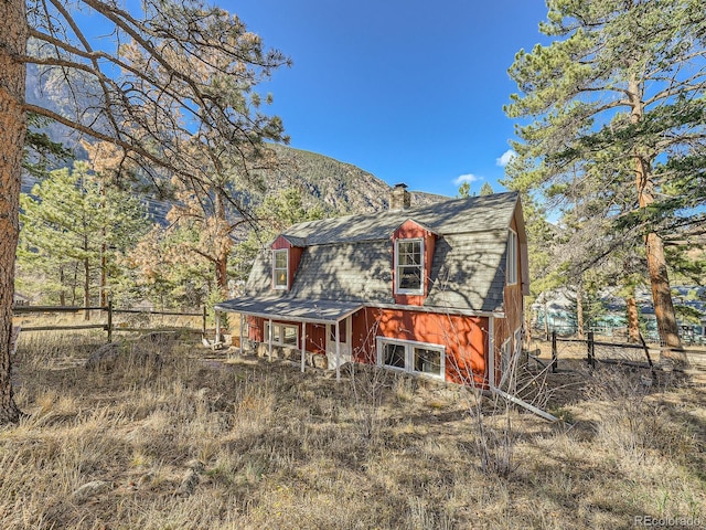 back of property with a mountain view