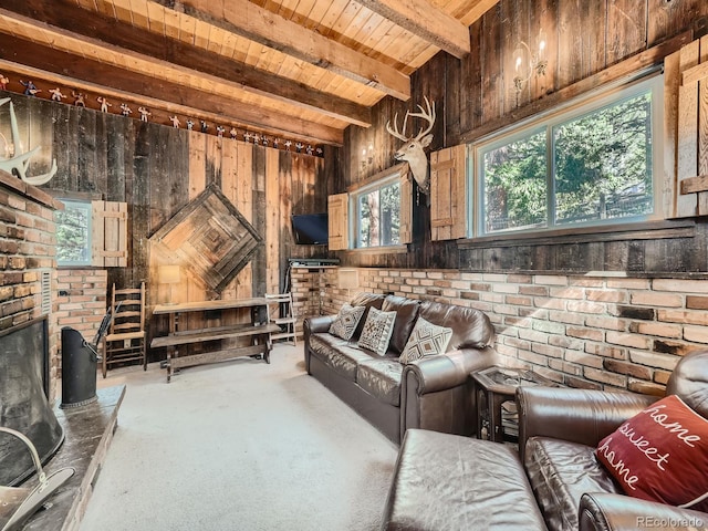 home theater featuring a wealth of natural light, brick wall, and beam ceiling