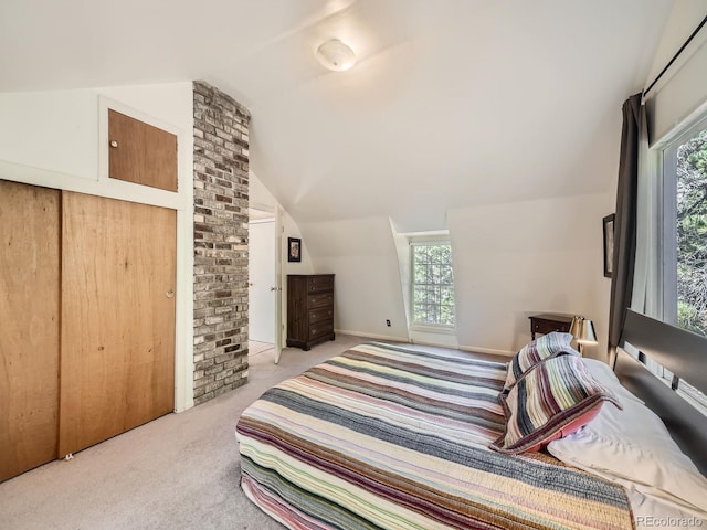 carpeted bedroom featuring lofted ceiling