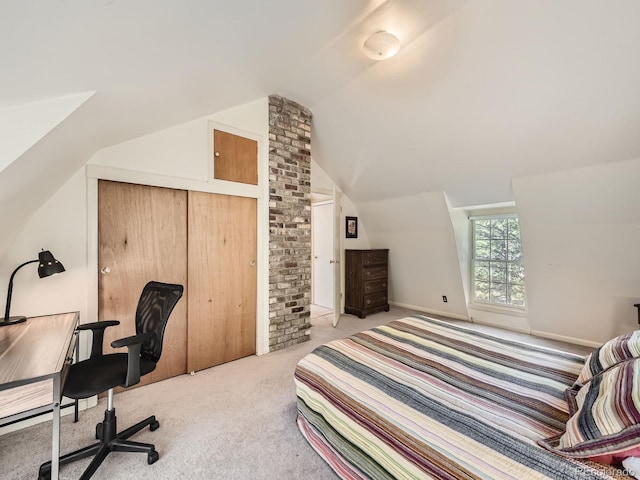 bedroom with lofted ceiling, a closet, and light colored carpet