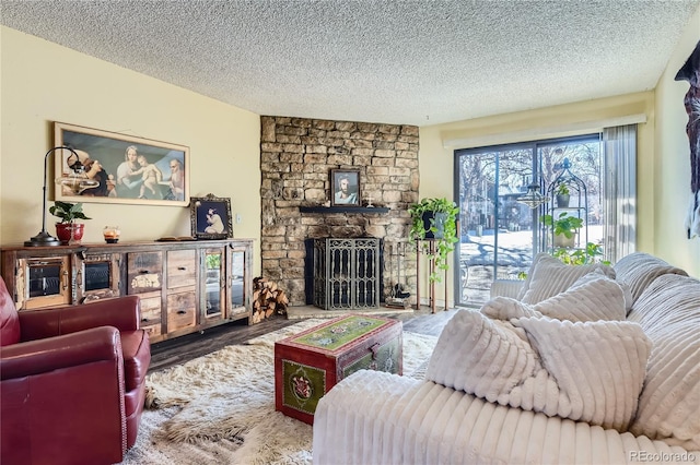 living room featuring a fireplace, hardwood / wood-style floors, and a textured ceiling