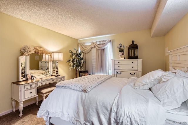 bedroom featuring carpet and a textured ceiling