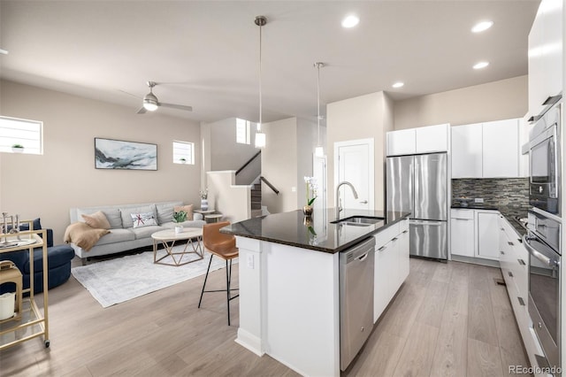 1928 W 67th Pl, Denver, CO 80221 - kitchen with appliances with stainless steel finishes, a sink, light wood finished floors, backsplash, and recessed lighting