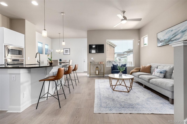 1928 W 67th Pl, Denver, CO 80221 - living room featuring a ceiling fan, light wood-type flooring, recessed lighting, and baseboards