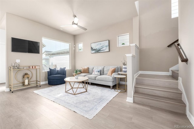1928 W 67th Pl, Denver, CO 80221 - living area featuring ceiling fan, stairway, baseboards, and light wood-style floors