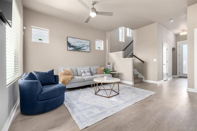 1928 W 67th Pl, Denver, CO 80221 - living room featuring light wood-style floors, stairway, ceiling fan, and baseboards