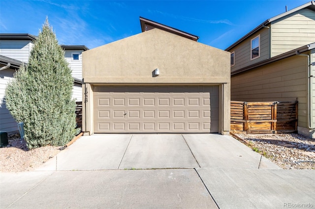 1928 W 67th Pl, Denver, CO 80221 - garage with driveway and fence