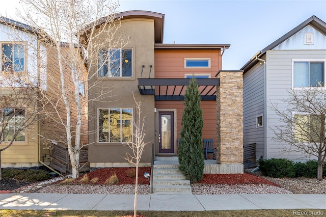 1928 W 67th Pl, Denver, CO 80221 - view of front of home with stucco siding, a standing seam roof, and metal roof