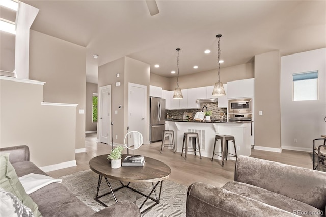 1928 W 67th Pl, Denver, CO 80221 - living room featuring recessed lighting and light wood-type flooring