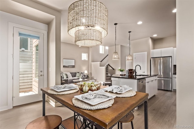 1928 W 67th Pl, Denver, CO 80221 - dining space featuring stairs, light wood-style floors, a chandelier, and recessed lighting