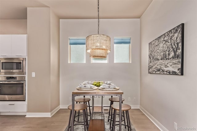 1928 W 67th Pl, Denver, CO 80221 - dining room featuring a chandelier and wood finished floors