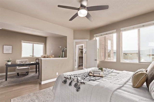 1928 W 67th Pl, Denver, CO 80221 - bedroom featuring wood finished floors, ceiling fan, and a spacious closet