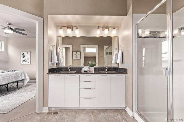 1928 W 67th Pl, Denver, CO 80221 - full bath featuring double vanity, a shower stall, ensuite bathroom, and ceiling fan
