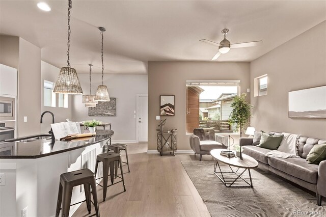 1928 W 67th Pl, Denver, CO 80221 - living area with plenty of natural light, ceiling fan, and light wood-type flooring