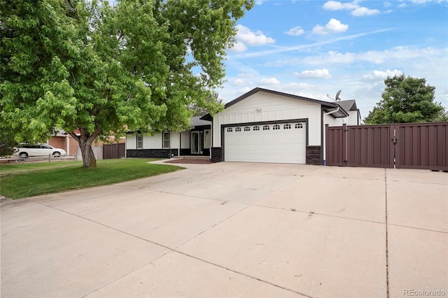 8595 S Yarrow St, Littleton, CO 80128 - ranch-style house with a garage, concrete driveway, and a gate