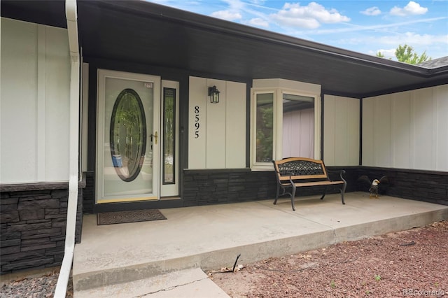 8595 S Yarrow St, Littleton, CO 80128 - doorway to property with stone siding and covered porch
