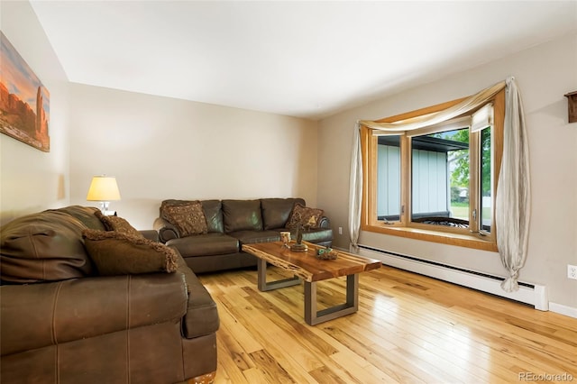8595 S Yarrow St, Littleton, CO 80128 - living room featuring baseboard heating and light wood-style floors