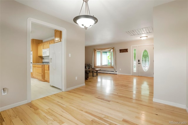 8595 S Yarrow St, Littleton, CO 80128 - foyer featuring a baseboard heating unit and light wood-style floors