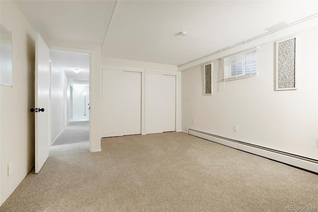 8595 S Yarrow St, Littleton, CO 80128 - below grade area featuring baseboard heating and light carpet