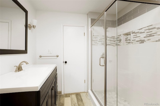 8595 S Yarrow St, Littleton, CO 80128 - full bath featuring vanity, a stall shower, and wood finished floors