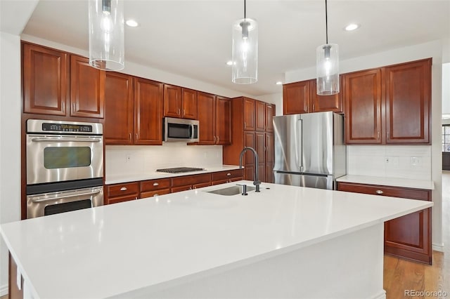 kitchen featuring stainless steel appliances, light countertops, and decorative backsplash