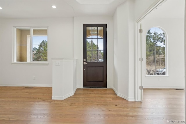 entryway with baseboards, light wood finished floors, visible vents, and recessed lighting