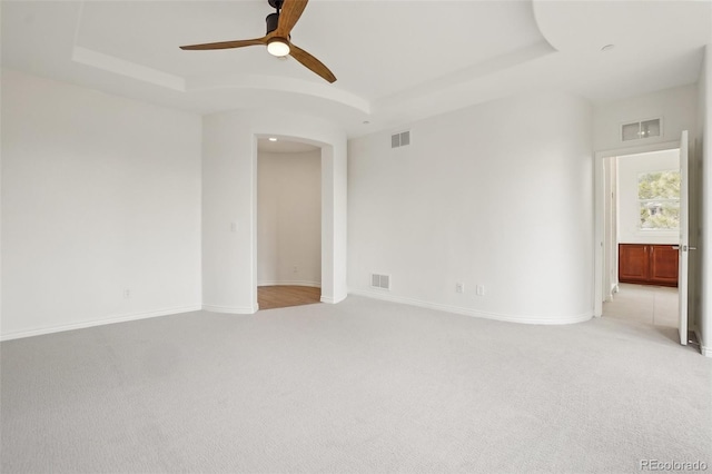 spare room with a raised ceiling and visible vents