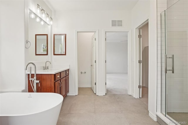 bathroom featuring a stall shower, a soaking tub, vanity, and visible vents