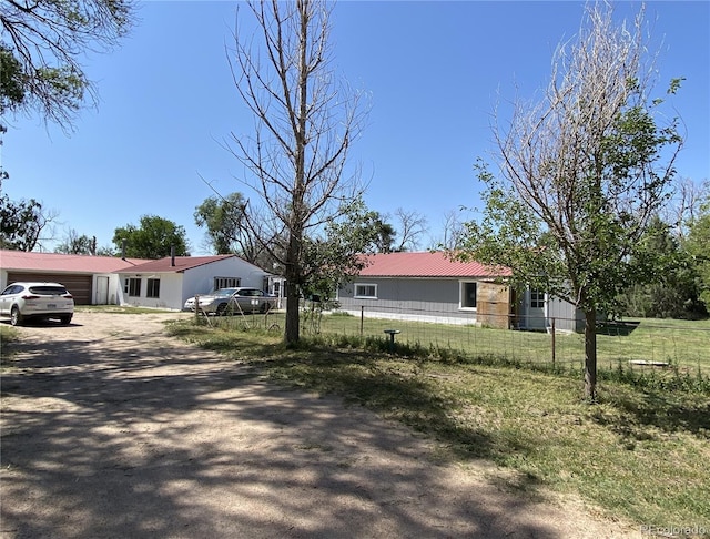 12729 Desert Dr, Sterling, CO 80751 - ranch-style house featuring driveway, a metal roof, and an attached garage