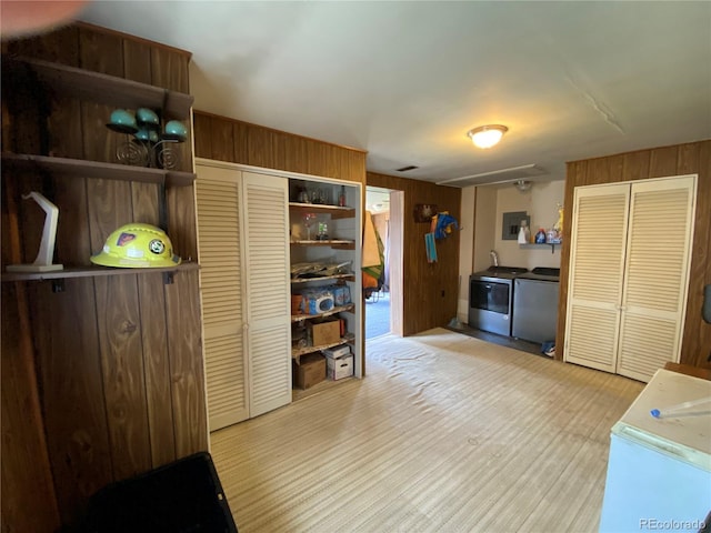 12729 Desert Dr, Sterling, CO 80751 - kitchen featuring open shelves, light wood-type flooring, wood walls, separate washer and dryer, and light countertops