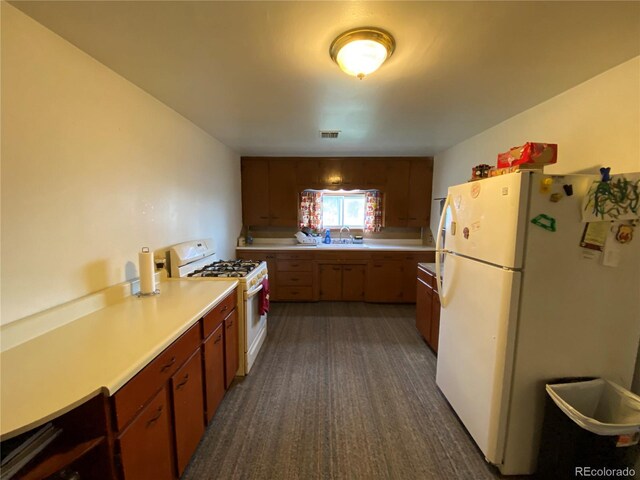 12729 Desert Dr, Sterling, CO 80751 - kitchen with white appliances and light countertops