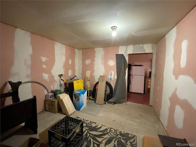 12729 Desert Dr, Sterling, CO 80751 - below grade area featuring freestanding refrigerator